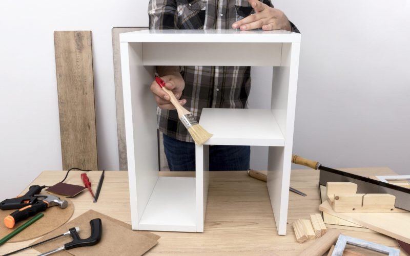 man-creating-cabinet-from-wood-front-view